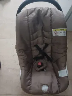 Beige newborn car seat with airbag warning