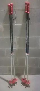 Pair of red ski poles with red baskets