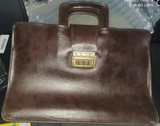 Vintage brown leather briefcase with golden clasp