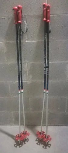 Pair of red ski poles with red baskets