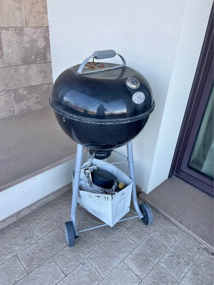 Black charcoal barbecue on wheels